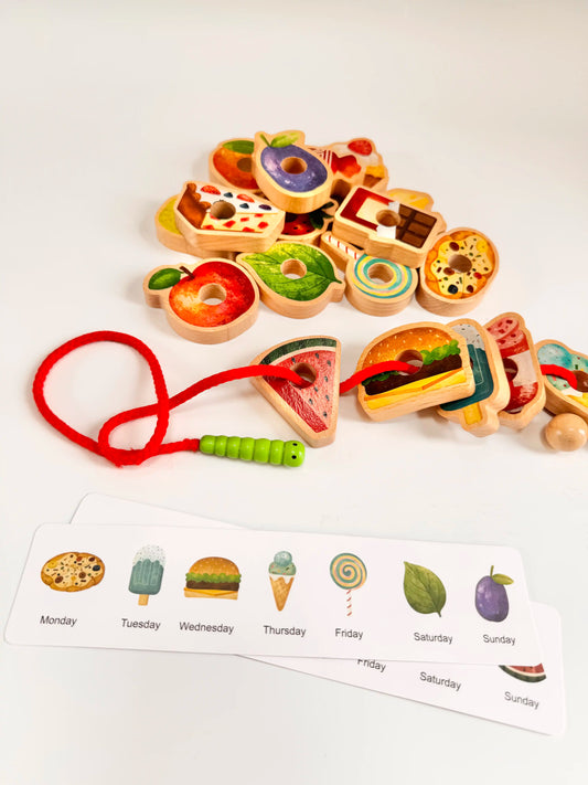 Colorful wooden food pieces and caterpillar threading toy with themed menu cards for imaginative play and learning.