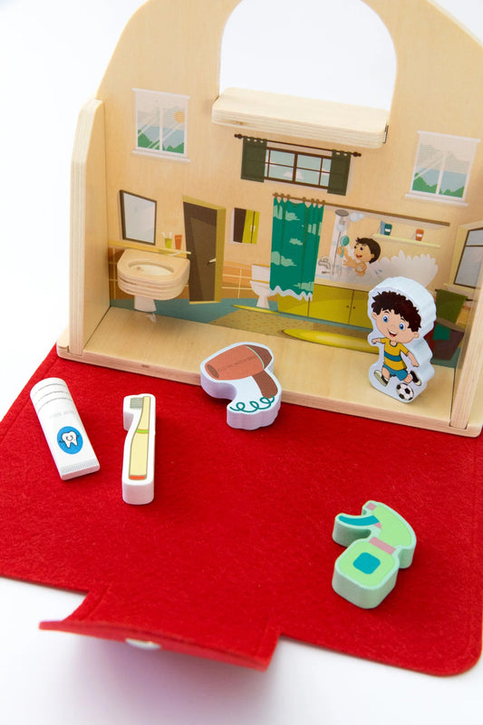 Foldable wooden pretend play house with character figures and fun accessories like toothbrush and soap.