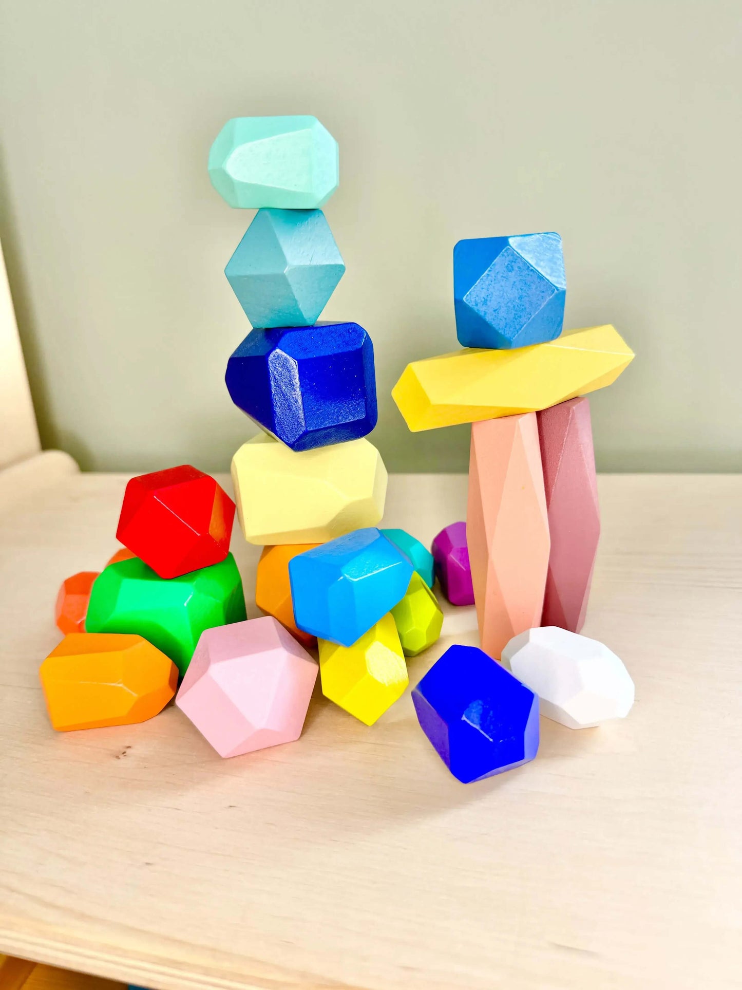 Colorful wooden stacking and balancing rocks for Montessori-inspired open-ended play; eco-friendly and perfect for developing coordination.