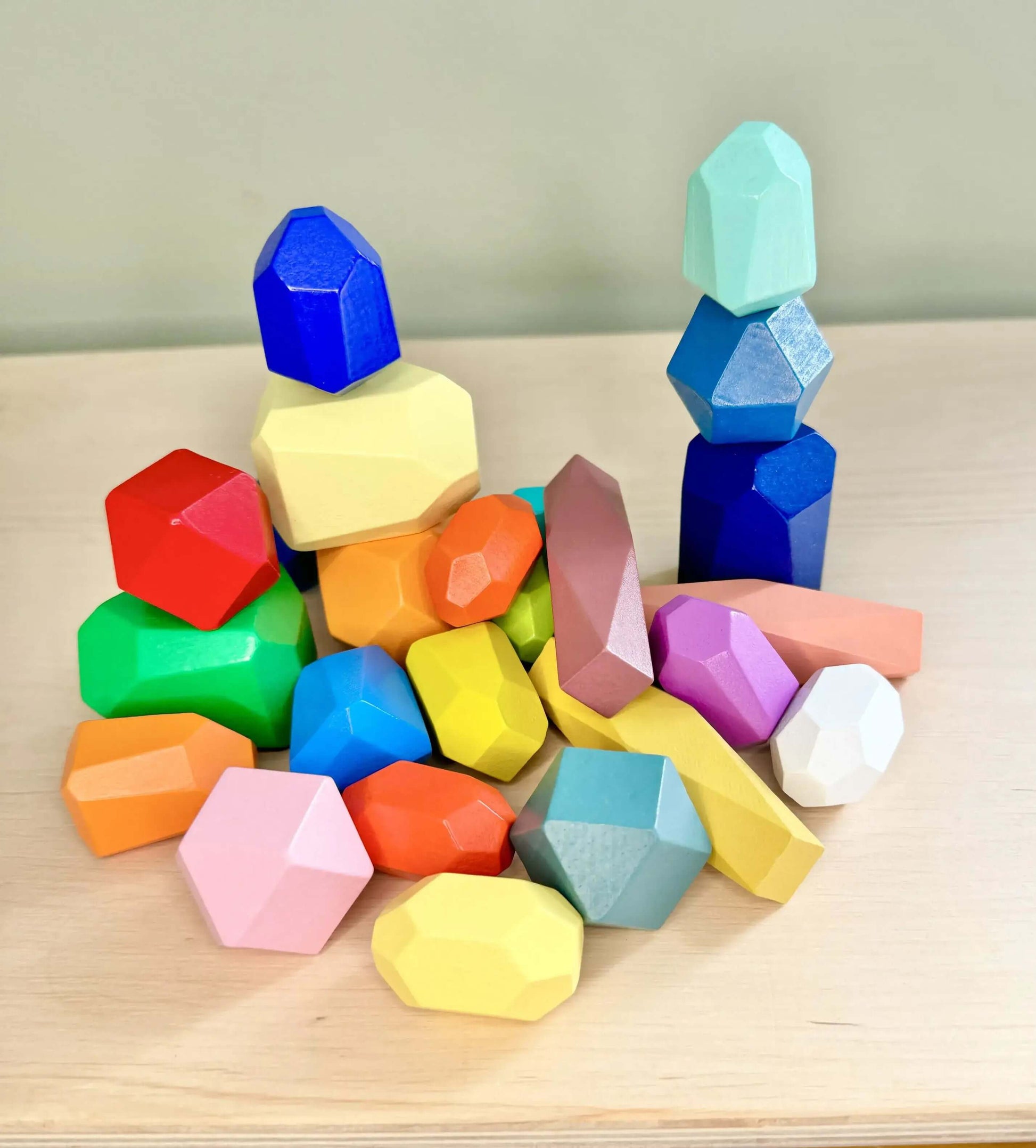 Colorful wooden stacking and balancing rocks for open-ended play and Montessori-inspired learning, crafted from natural eco-friendly wood.