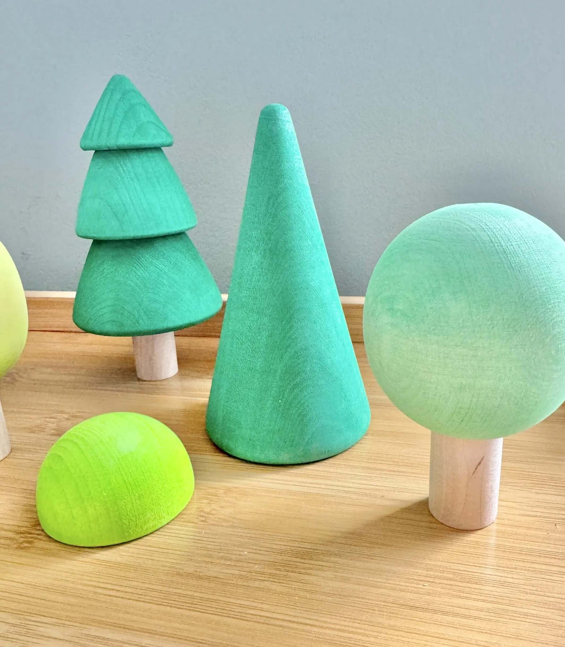 Handcrafted wooden green forest trees set for Montessori-inspired, open-ended play, eco-friendly and handmade toys.