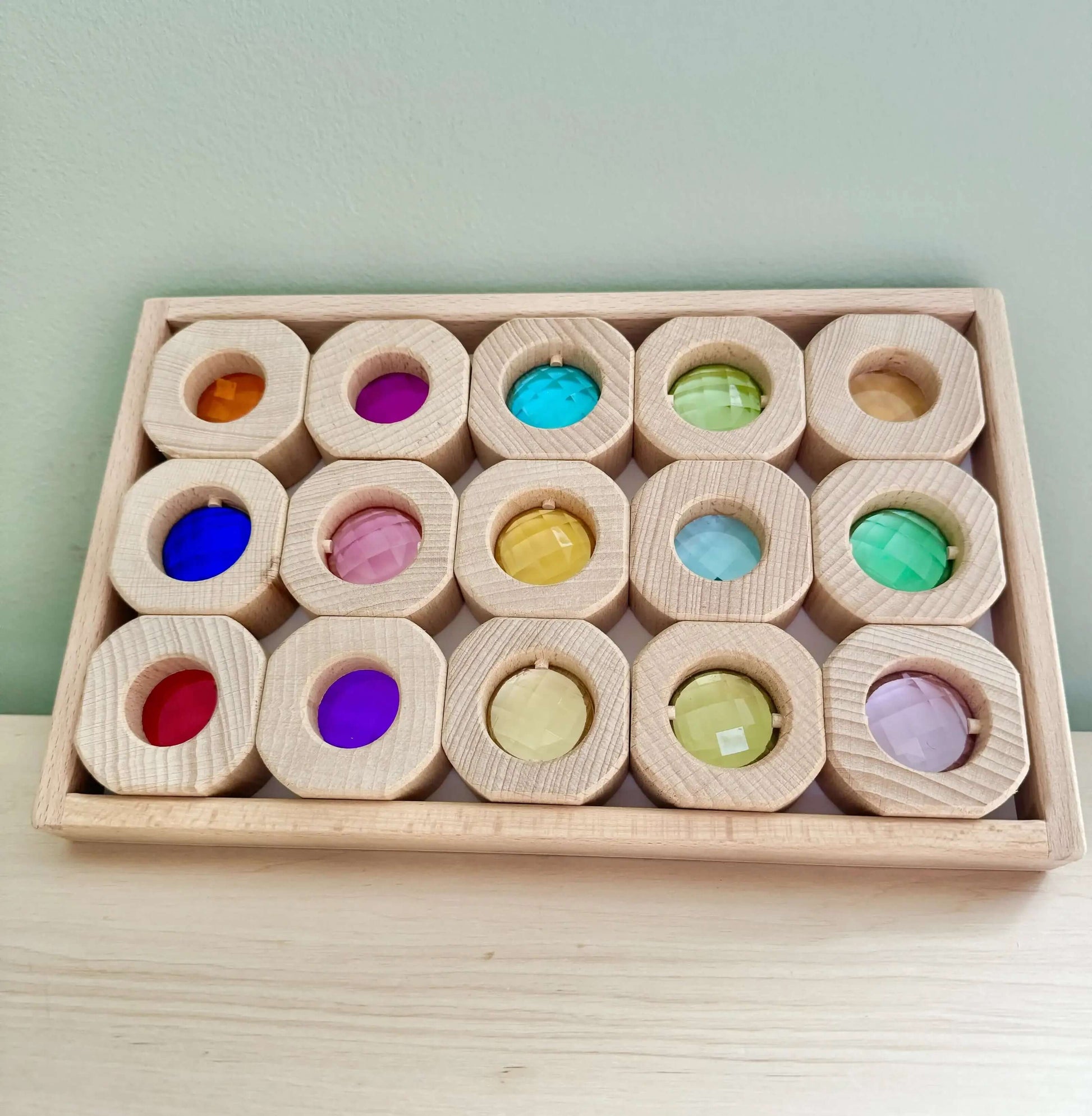 Wooden and acrylic light blocks set in a wooden tray, ideal for eco-friendly, Montessori-inspired open-ended play.