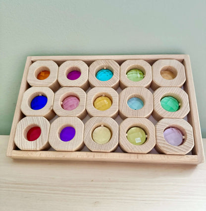 Wooden and acrylic light blocks set in a wooden tray, ideal for eco-friendly, Montessori-inspired open-ended play.