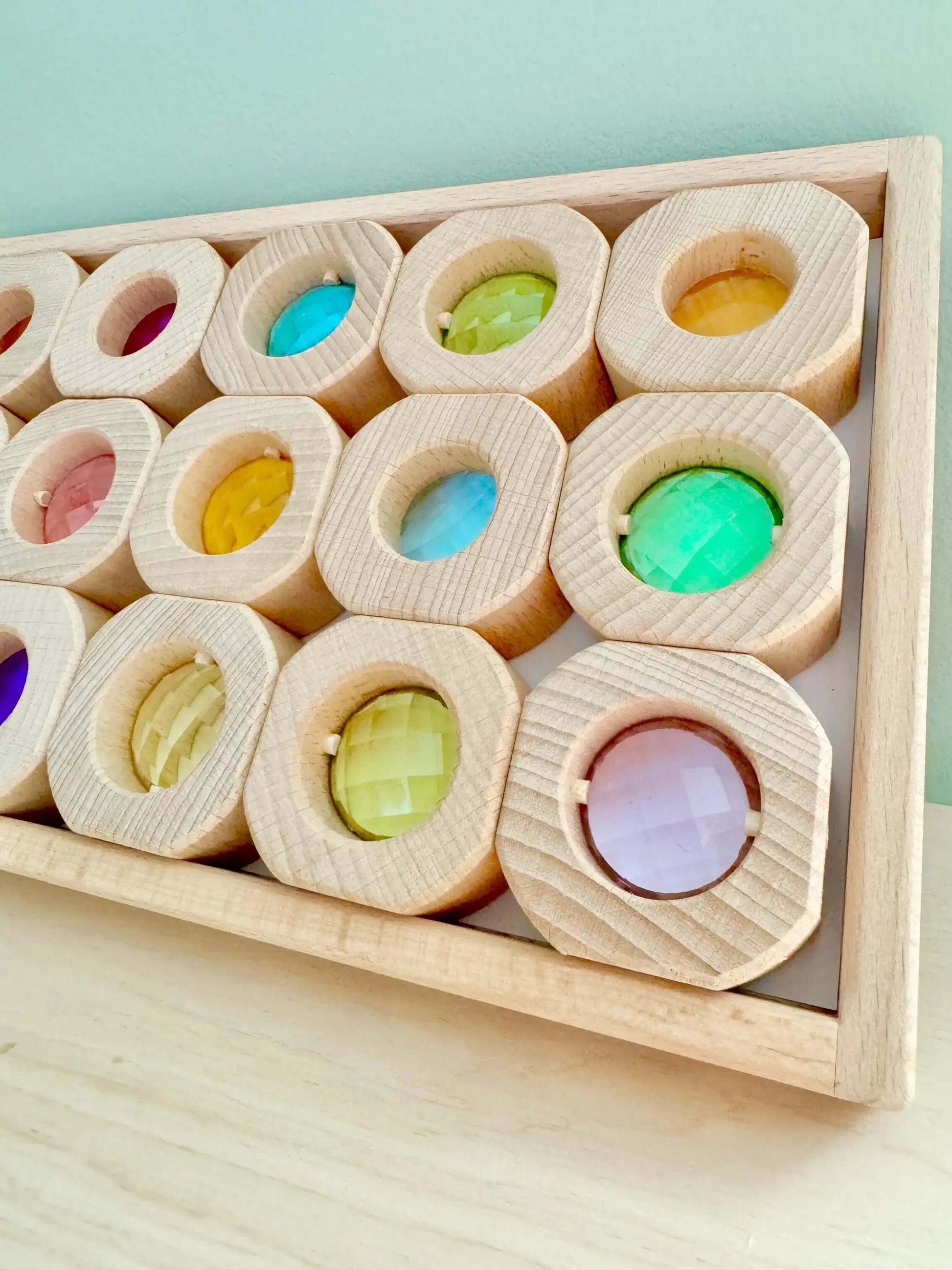 Wooden and acrylic light blocks in a tray, showcasing colorful, eco-friendly, Montessori-inspired, open-ended play toys.