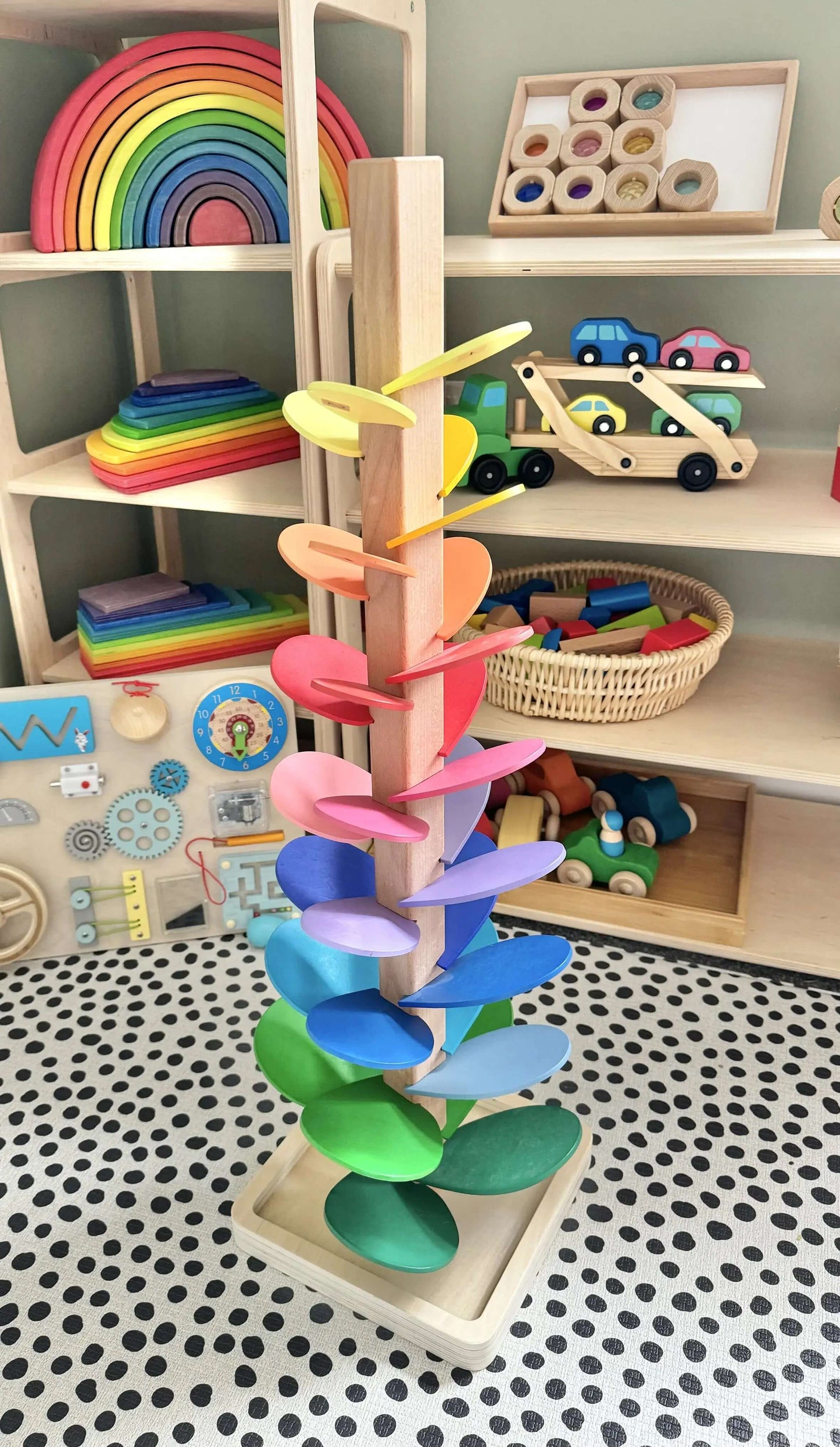 Rainbow Music Tree wooden toy with colorful leaves in a Montessori inspired playroom, promoting open-ended and eco-friendly play.