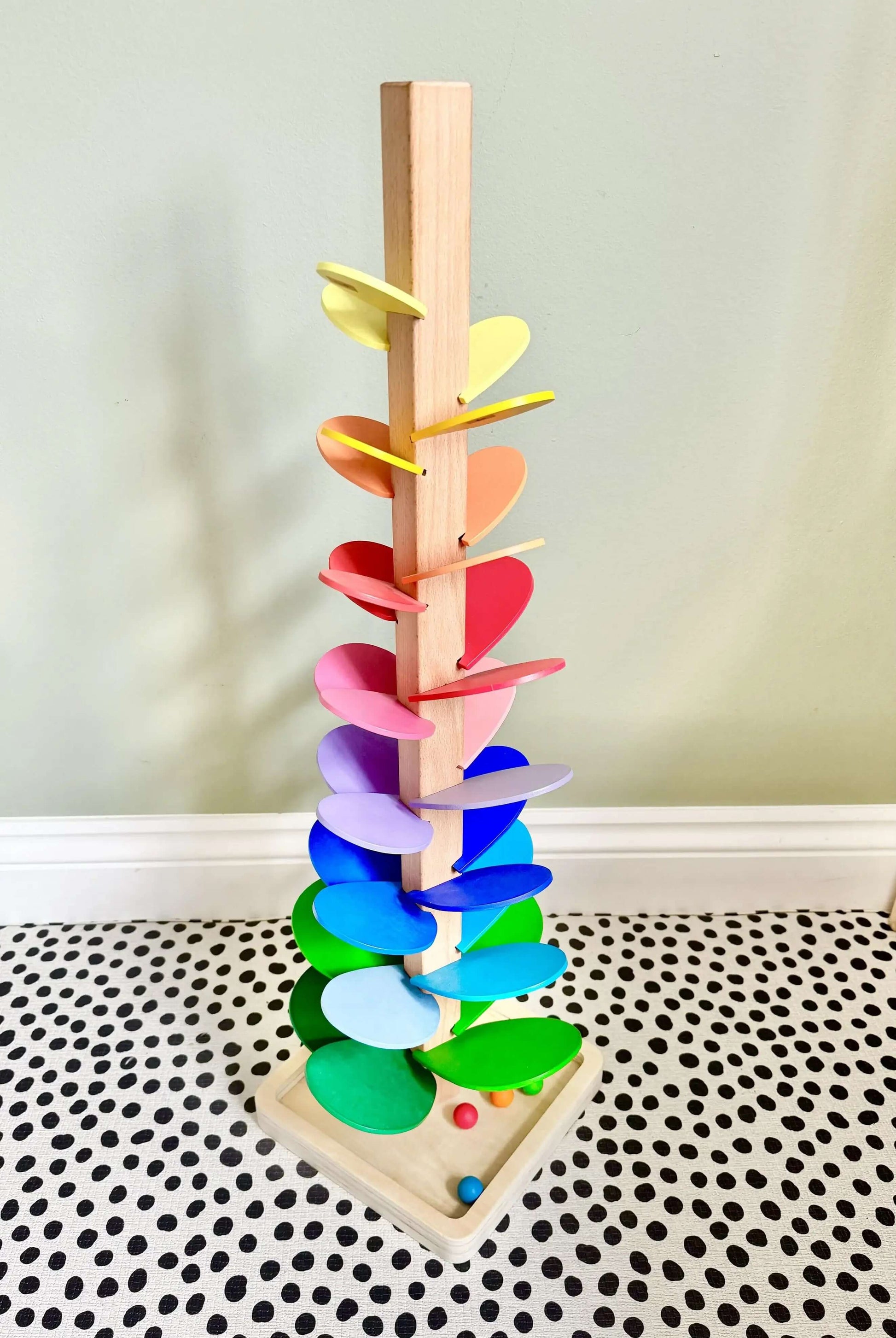 Montessori inspired Rainbow Music Tree wooden toy with colorful leaves for open-ended play and fine motor skill development. Eco-friendly and non-toxic.