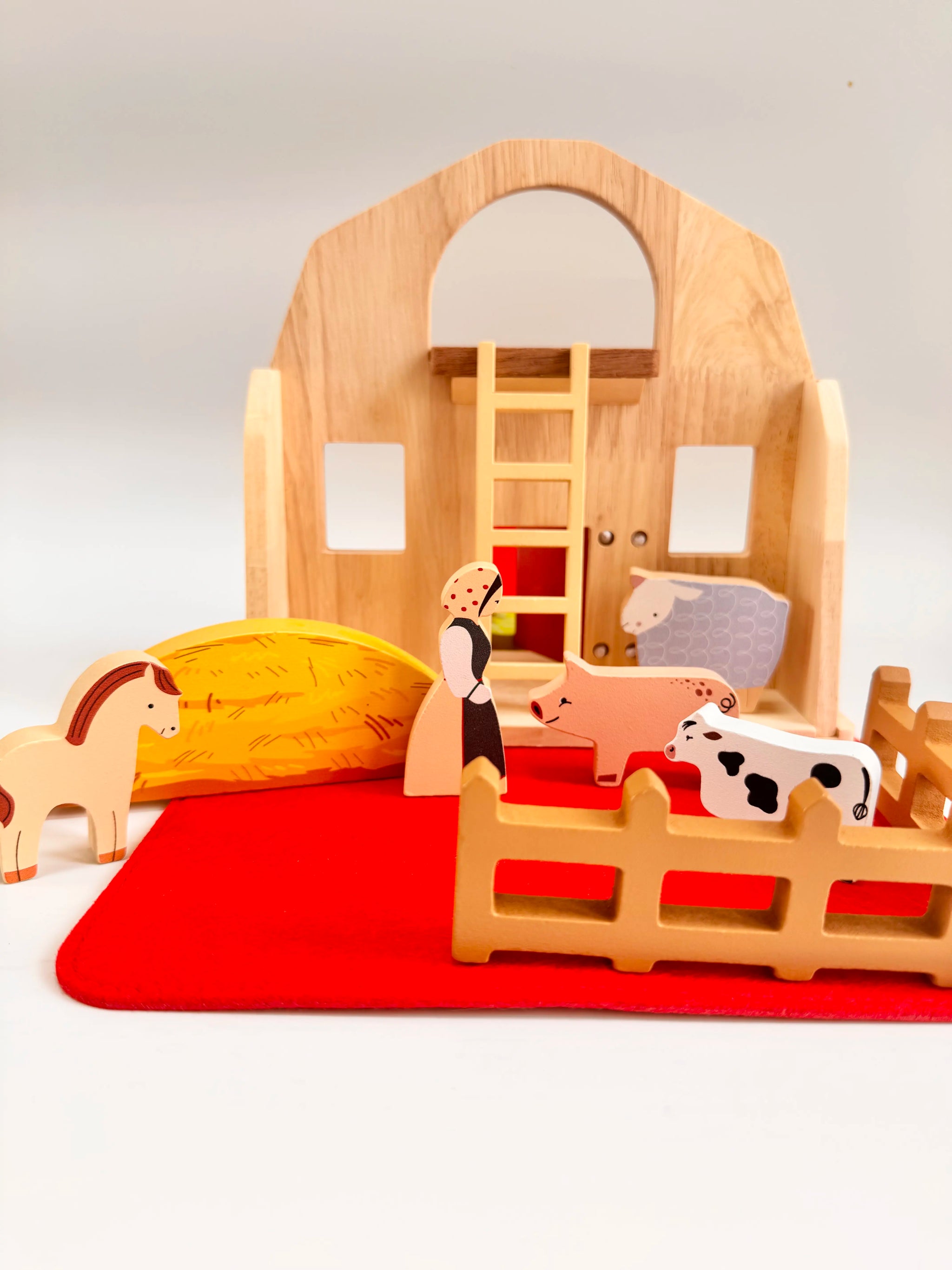Folding Wooden Farmyard House with figures, animals, and accessories for imaginative play.
