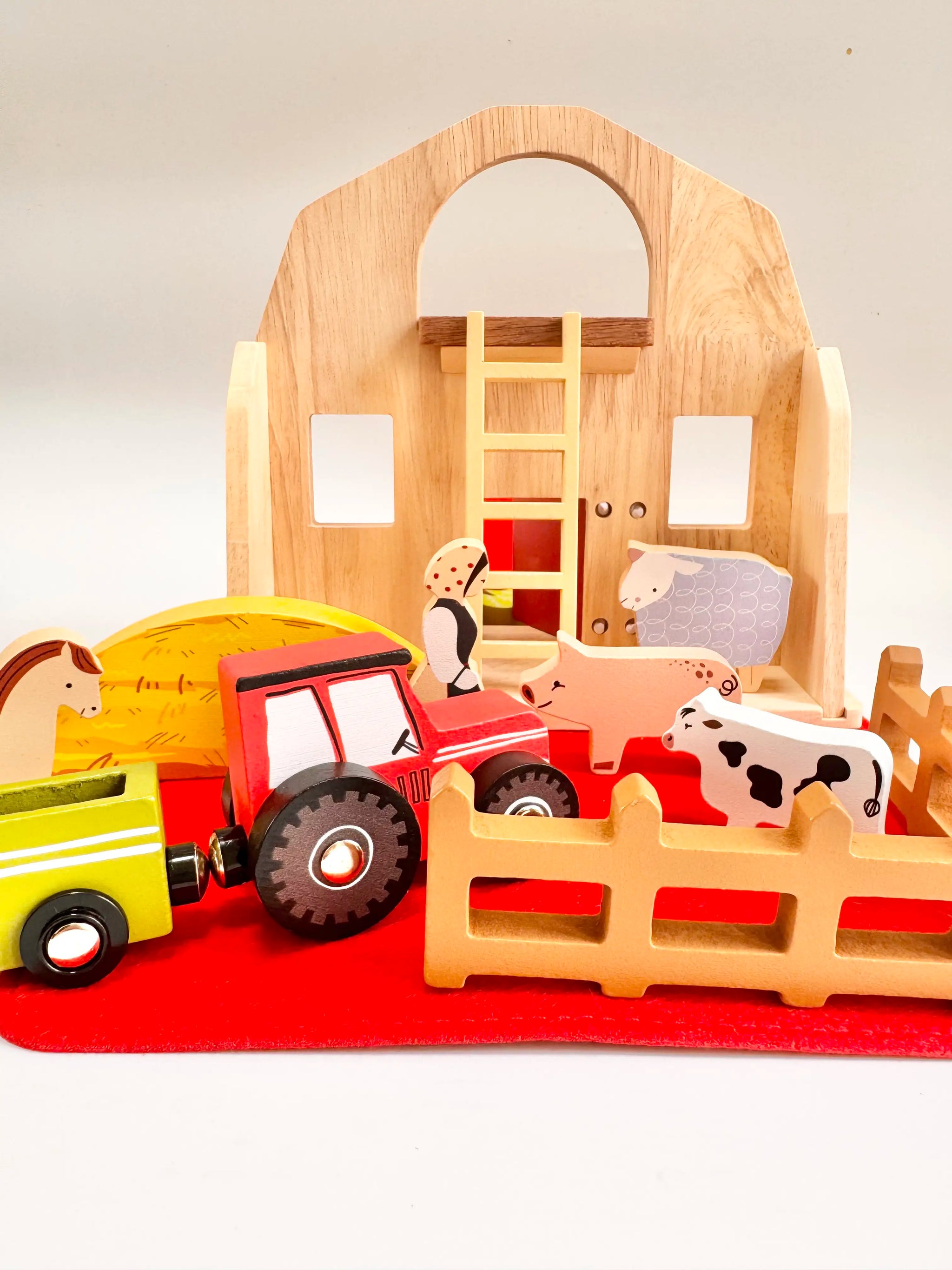 Colorful Folding Wooden Farmyard House toy with animals and tractor, perfect for toddlers' imaginative play.