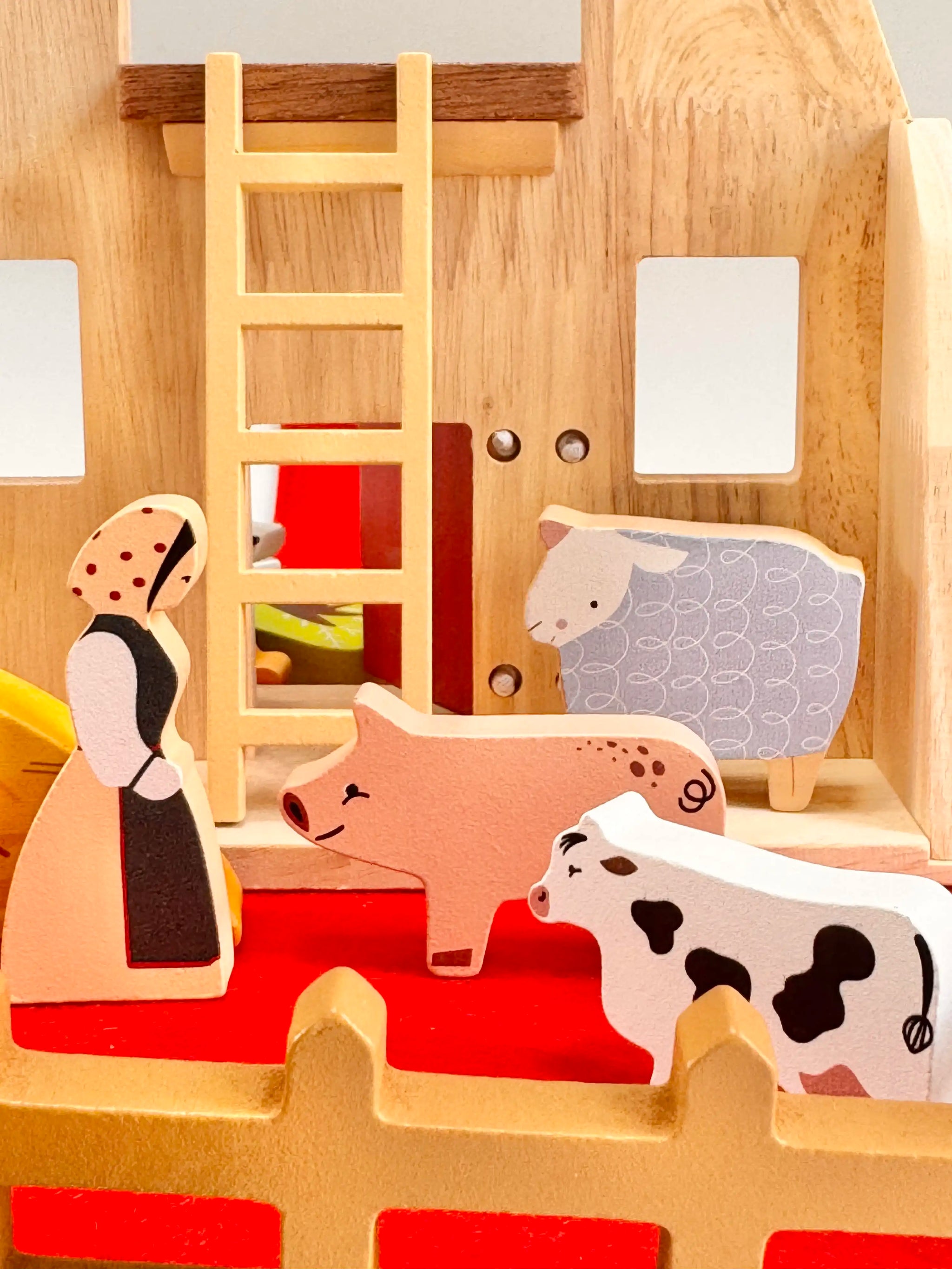 Folding Wooden Farmyard House with figures including a farmer, pig, sheep, and cow for imaginative play.