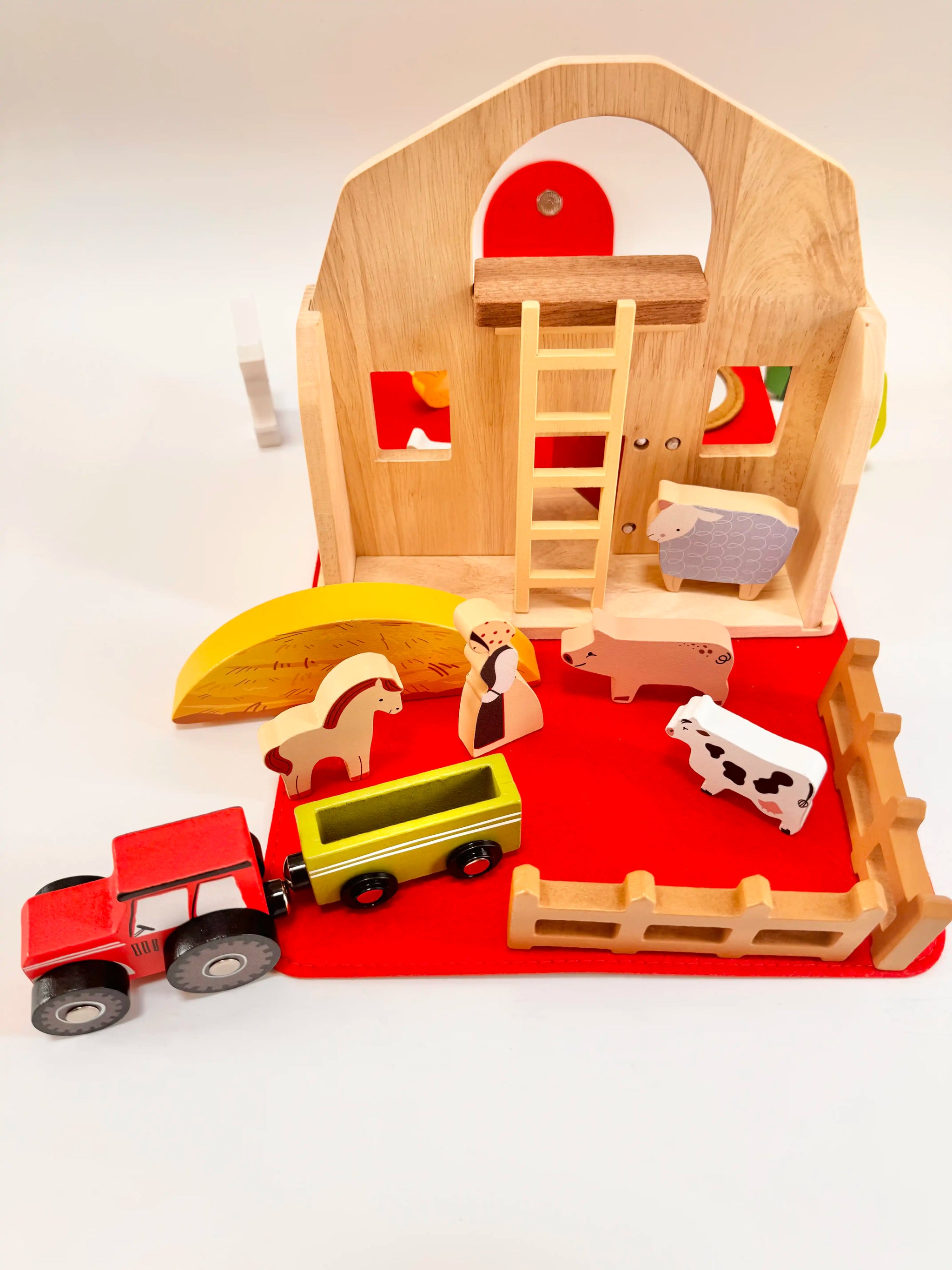 Colorful Folding Wooden Farmyard House with figures, tractor, and accessories for imaginative play.