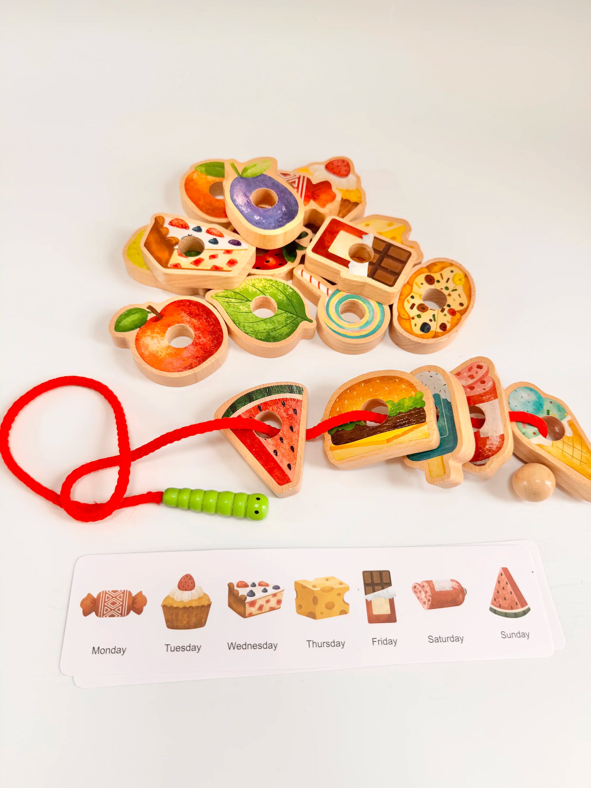 Colorful wooden caterpillar threading set with food pieces and menu cards for creative play and learning.