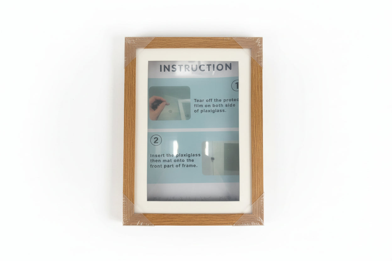 Wooden picture frame with clear plastic cover displaying installation instructions.