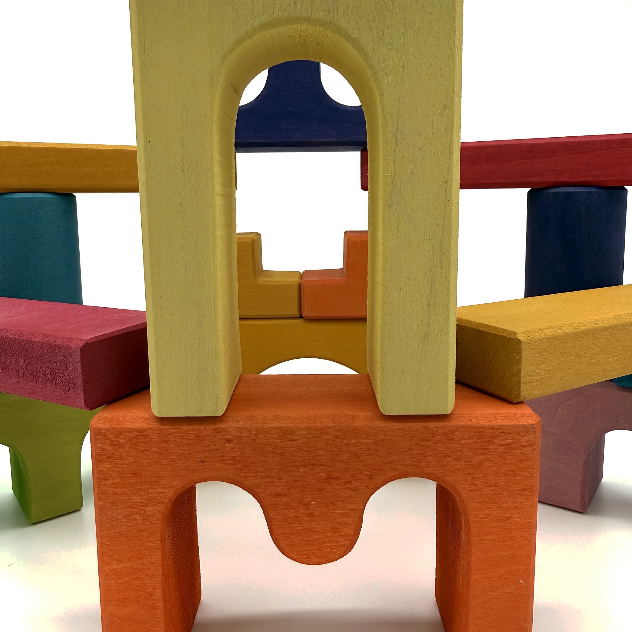 Close-up castle wooden building blocks with archways and bridge pieces