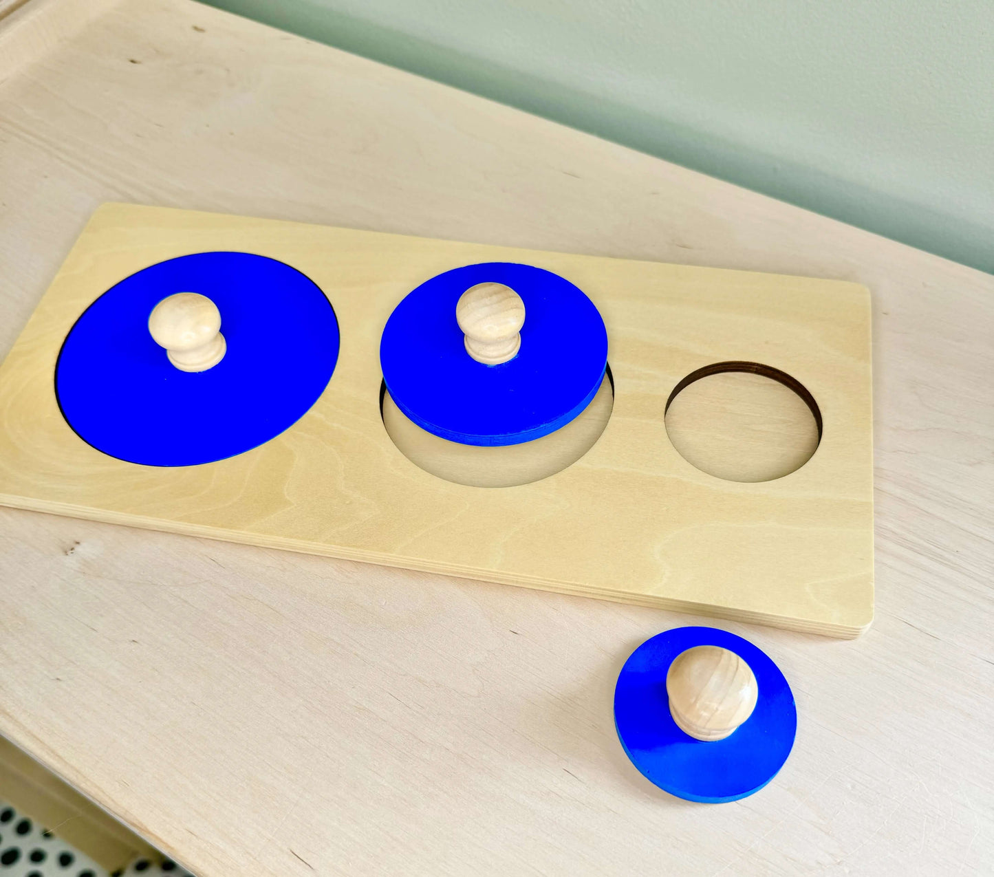 Montessori inspired wooden toy puzzle set with blue circle shapes for open-ended eco-friendly play and spatial reasoning skills development