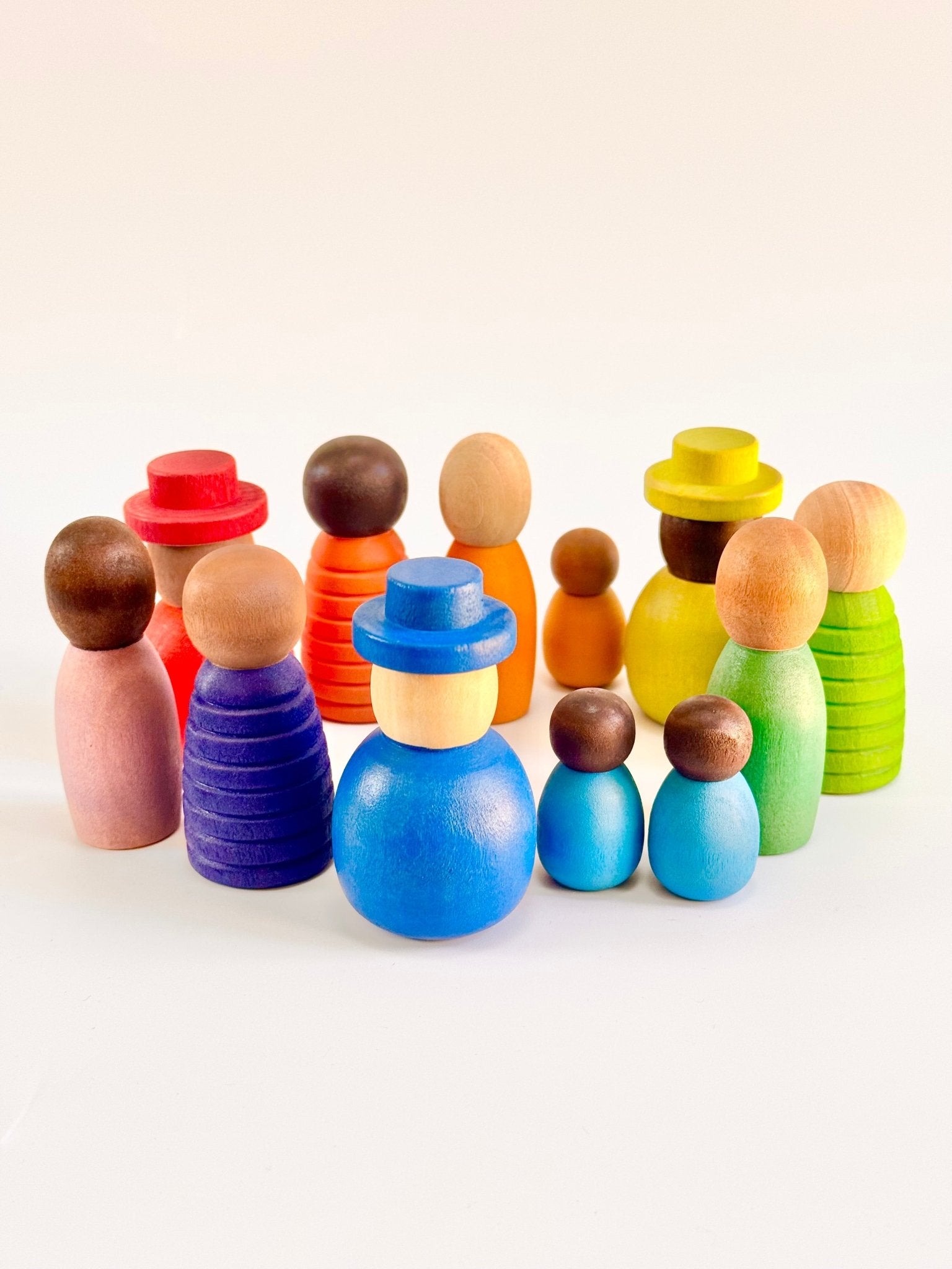 Colorful wooden peg dolls set of 12 in various shapes and sizes, celebrating diversity and imaginative play.