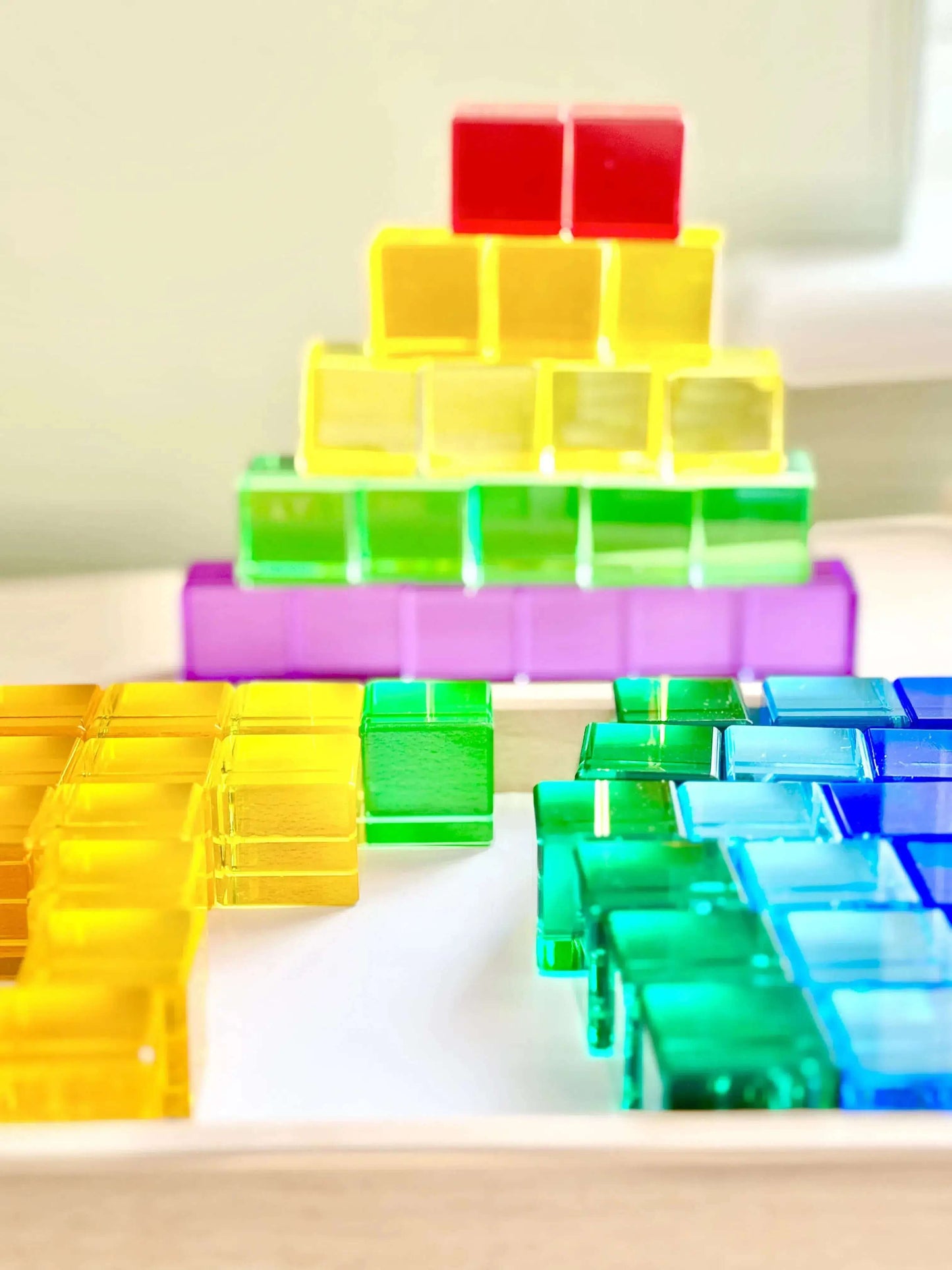 Colorful Permeability Cubes stacked in vibrant patterns for open-ended Montessori-inspired play, promoting learning and creativity.