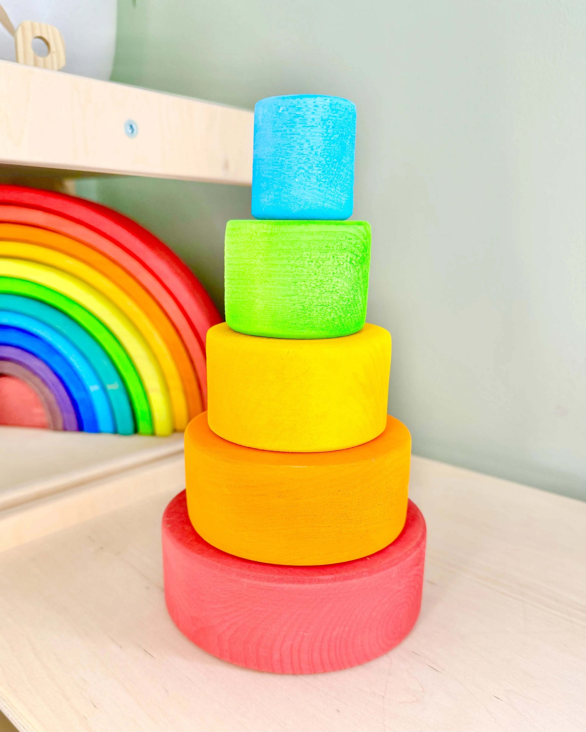 Rainbow Nesting Cups wooden toy arranged in a stack, perfect for Montessori inspired, open-ended play. Eco-friendly and safe for toddlers.