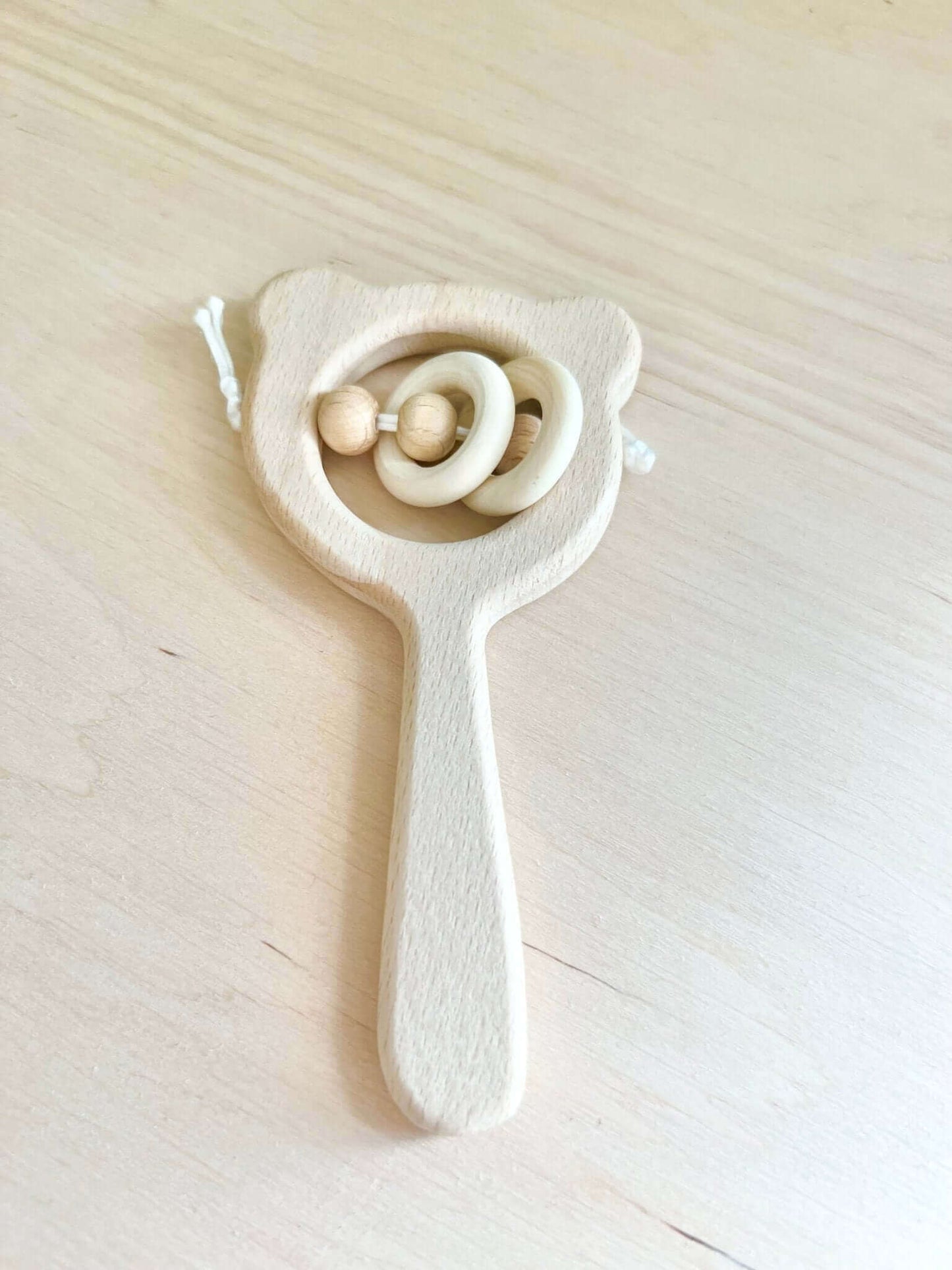 Wooden Montessori-inspired baby rattle toy for open-ended play and sensory development. Eco-friendly and perfect for newborns.