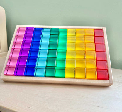 Colorful Permeability Cubes set on wooden tray for Montessori-inspired open-ended play and spatial learning.