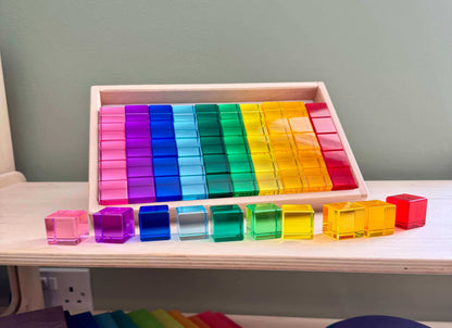 Acrylic Permeability Cubes set displayed in a wooden tray, showcasing vibrant colors for open-ended, Montessori-inspired education and eco-friendly play.