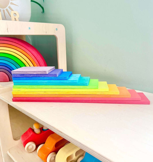 Wooden Rainbow Building Boards set arranged on a shelf, perfect for Montessori inspired, open-ended play, and eco-friendly toy development.