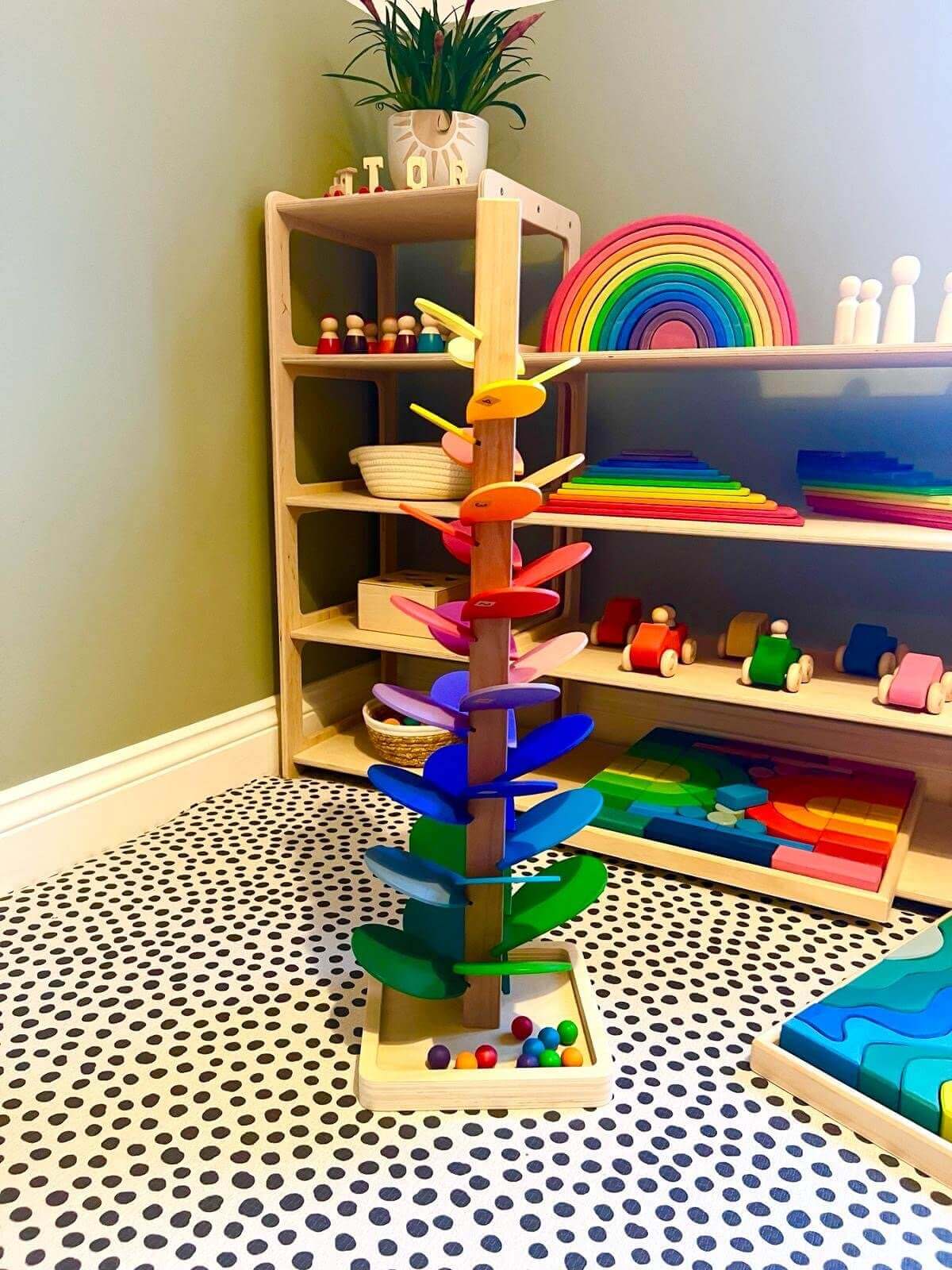 Wooden Rainbow Music Tree in Montessori playroom, featuring colorful wooden leaves for open-ended play and fine motor skill development.