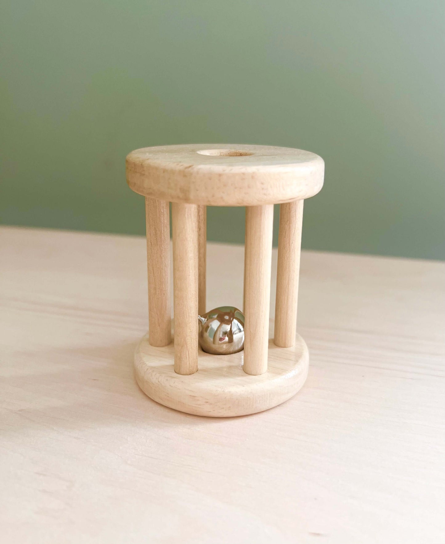 Wooden rolling bell toy for Montessori-inspired, eco-friendly, open-ended play, ideal for toddlers’ sensory learning