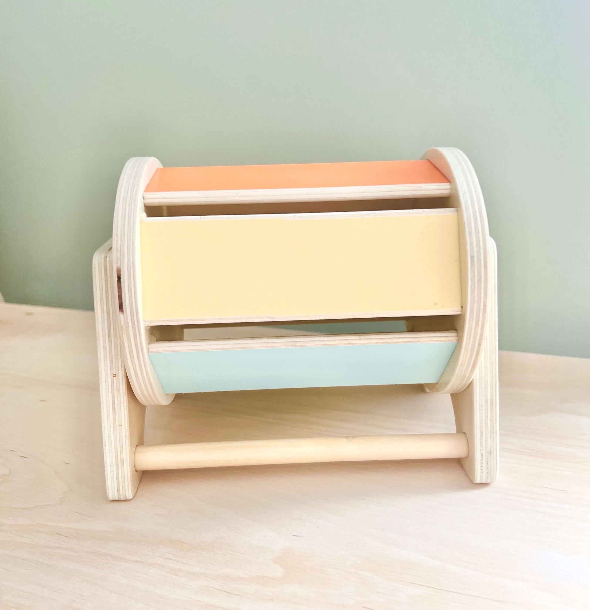 Eco-friendly wooden spinning drum toy for Montessori-inspired open-ended play, ideal for toddlers' sensory development