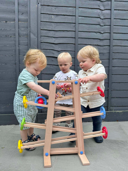 Children engaging with a wooden shape ramp toy for open-ended play, promoting Montessori-inspired learning and creativity.