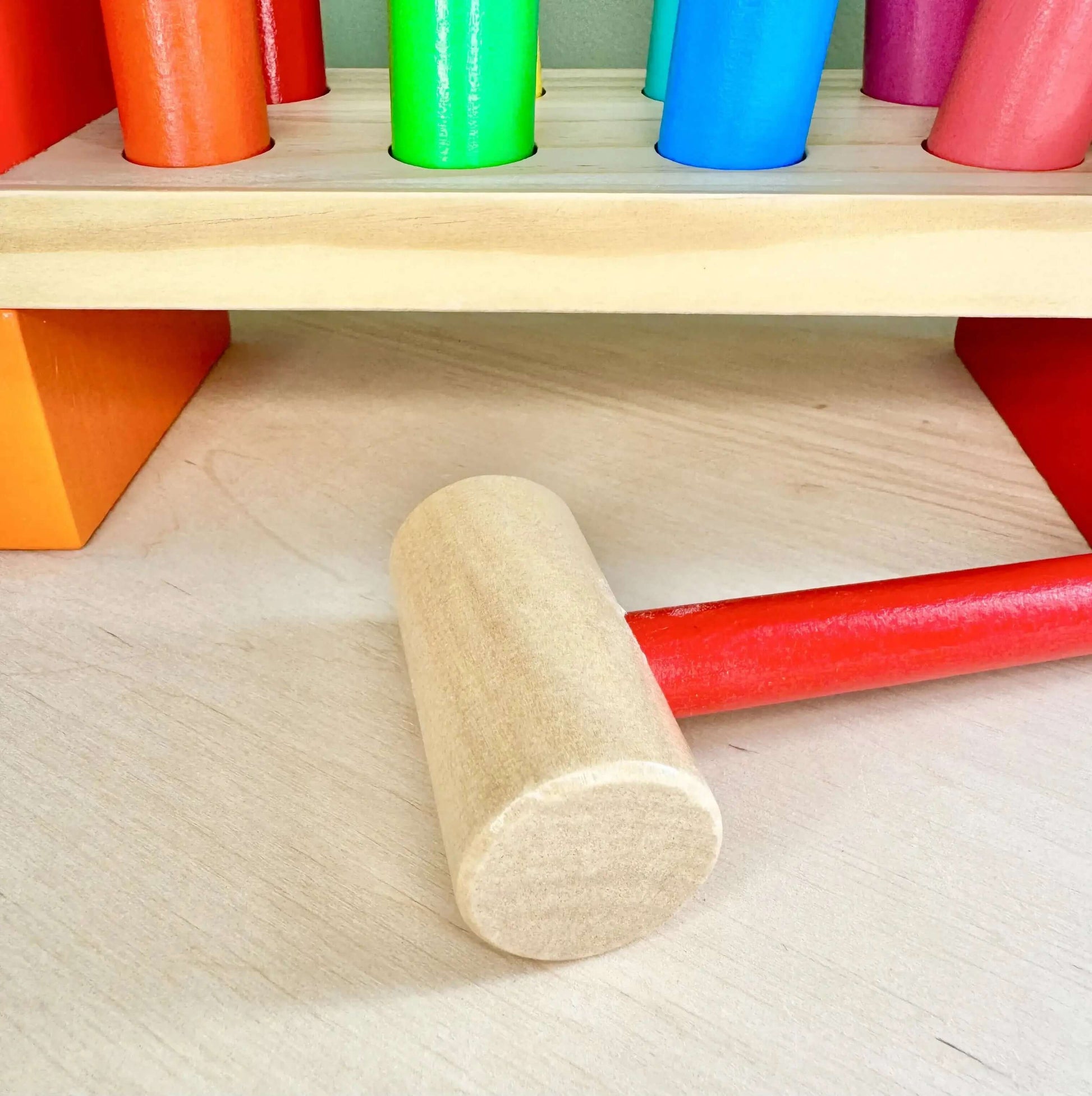 Wooden peg bench with colorful pegs and hammer, Montessori inspired toy for open-ended play and enhancing fine motor skills